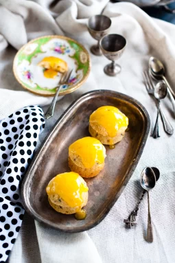 Small gluten free passionfruit cakes topped with smooth lime curd icing, showing a light, fluffy crumb and fresh passionfruit seeds; a bright and zesty mini cake dessert.