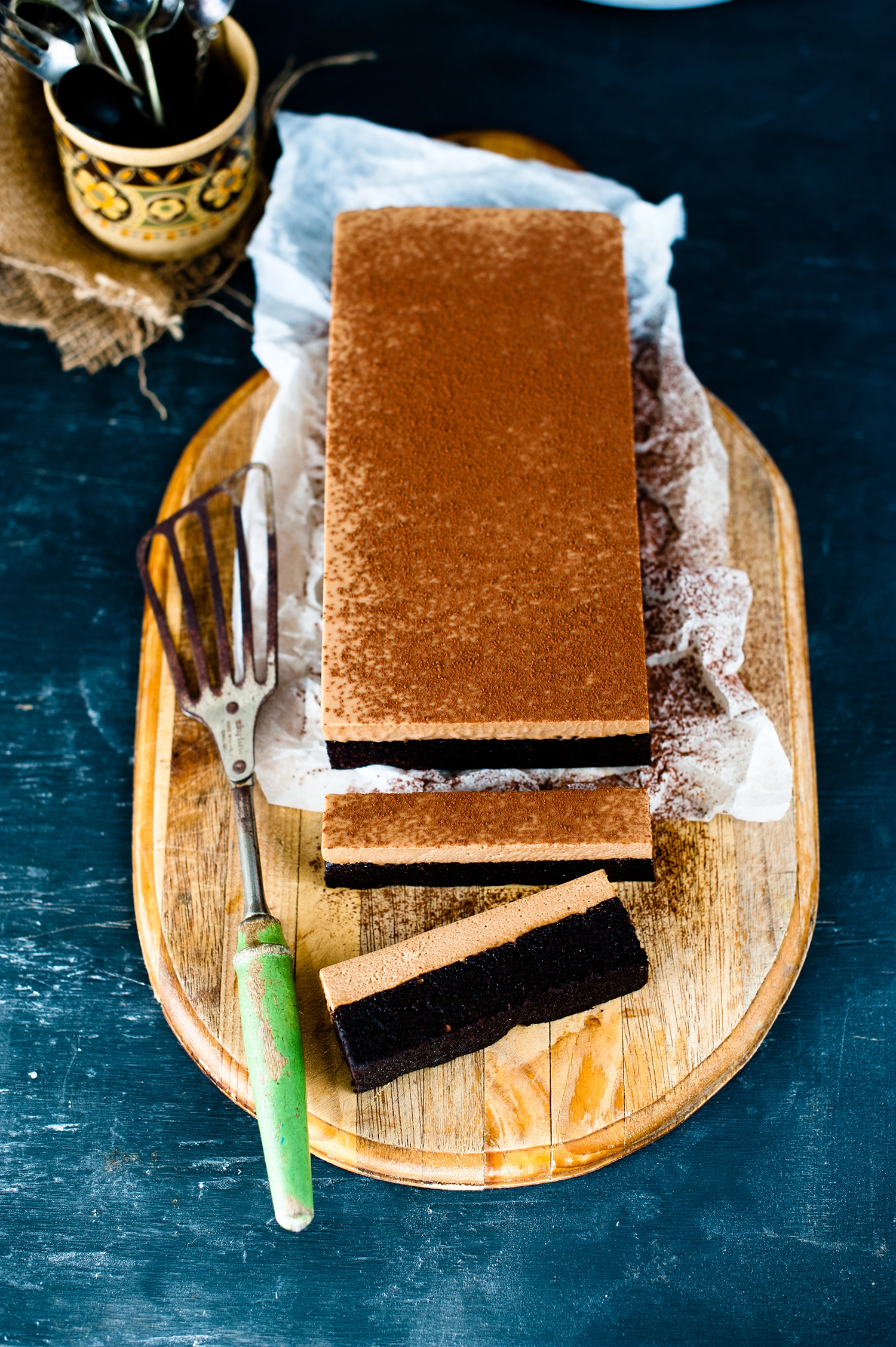 A rich gluten free chocolate brownie cake layered with smooth chocolate mousse and dusted with cocoa powder; a decadent gluten free dessert perfect for celebrations.