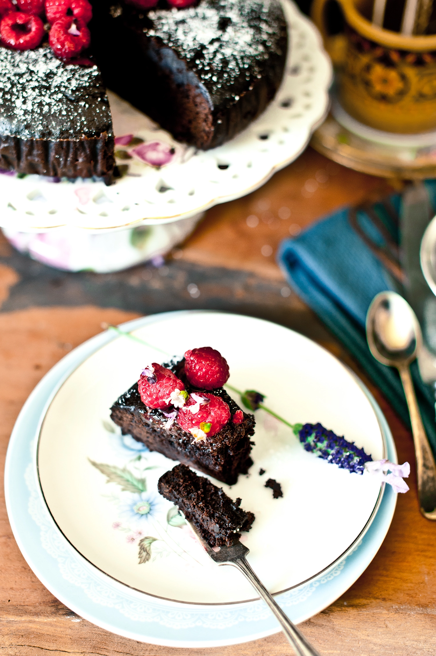 A dense, moist gluten free and dairy free chocolate mud cake made with kombucha, sliced to show its rich fudgy crumb; dark chocolate cake topped simply and perfect for allergy-friendly baking.