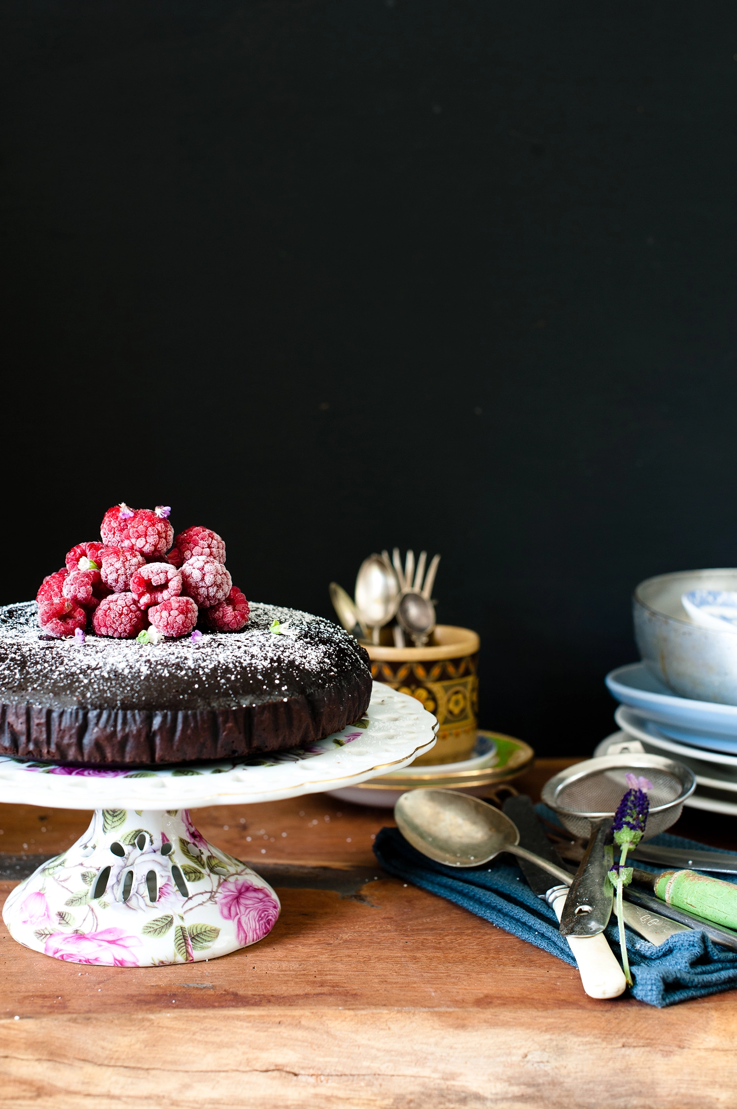 A dense, moist gluten free and dairy free chocolate mud cake made with kombucha, sliced to show its rich fudgy crumb; dark chocolate cake topped simply and perfect for allergy-friendly baking.