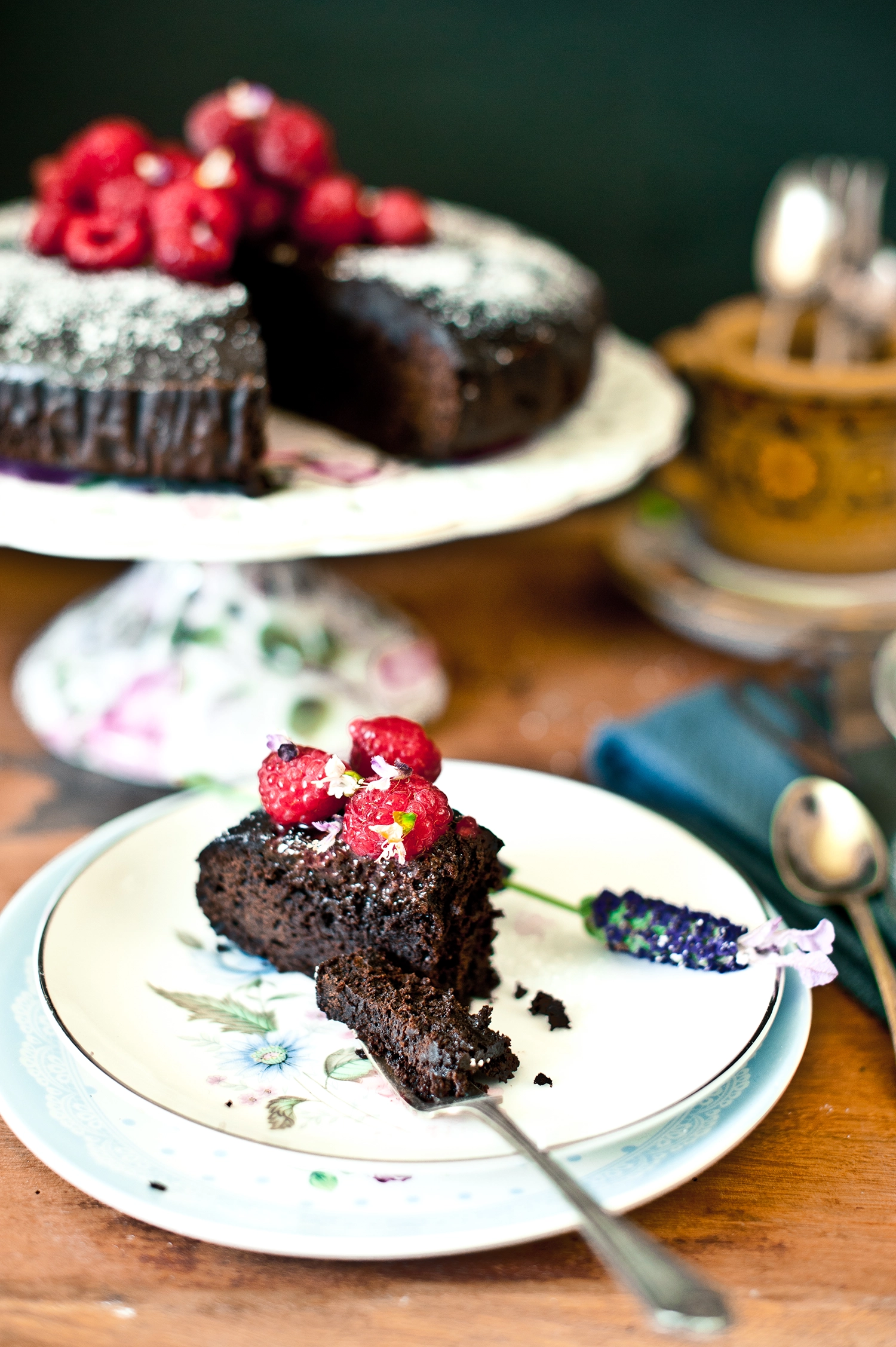 A dense, moist gluten free and dairy free chocolate mud cake made with kombucha, sliced to show its rich fudgy crumb; dark chocolate cake topped simply and perfect for allergy-friendly baking.