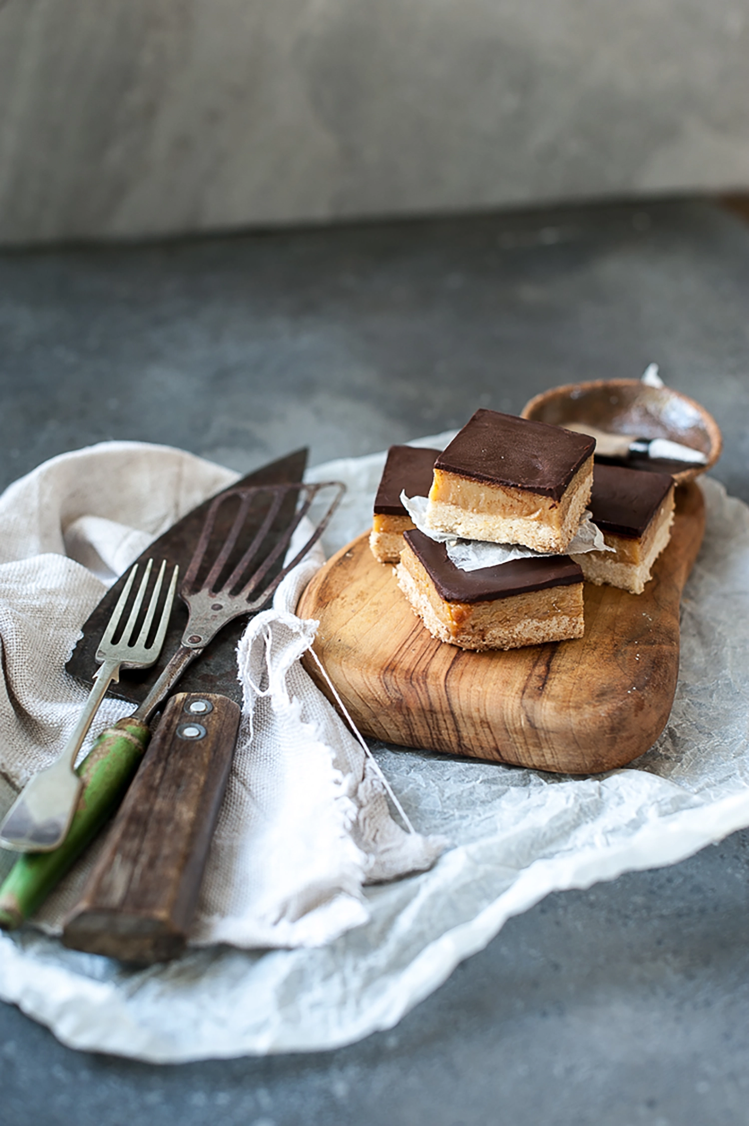 Gluten free salted caramel slice with buttery coconut base, thick caramel filling and smooth dark chocolate topping. The perfect sweet and salty treat for afternoon tea.