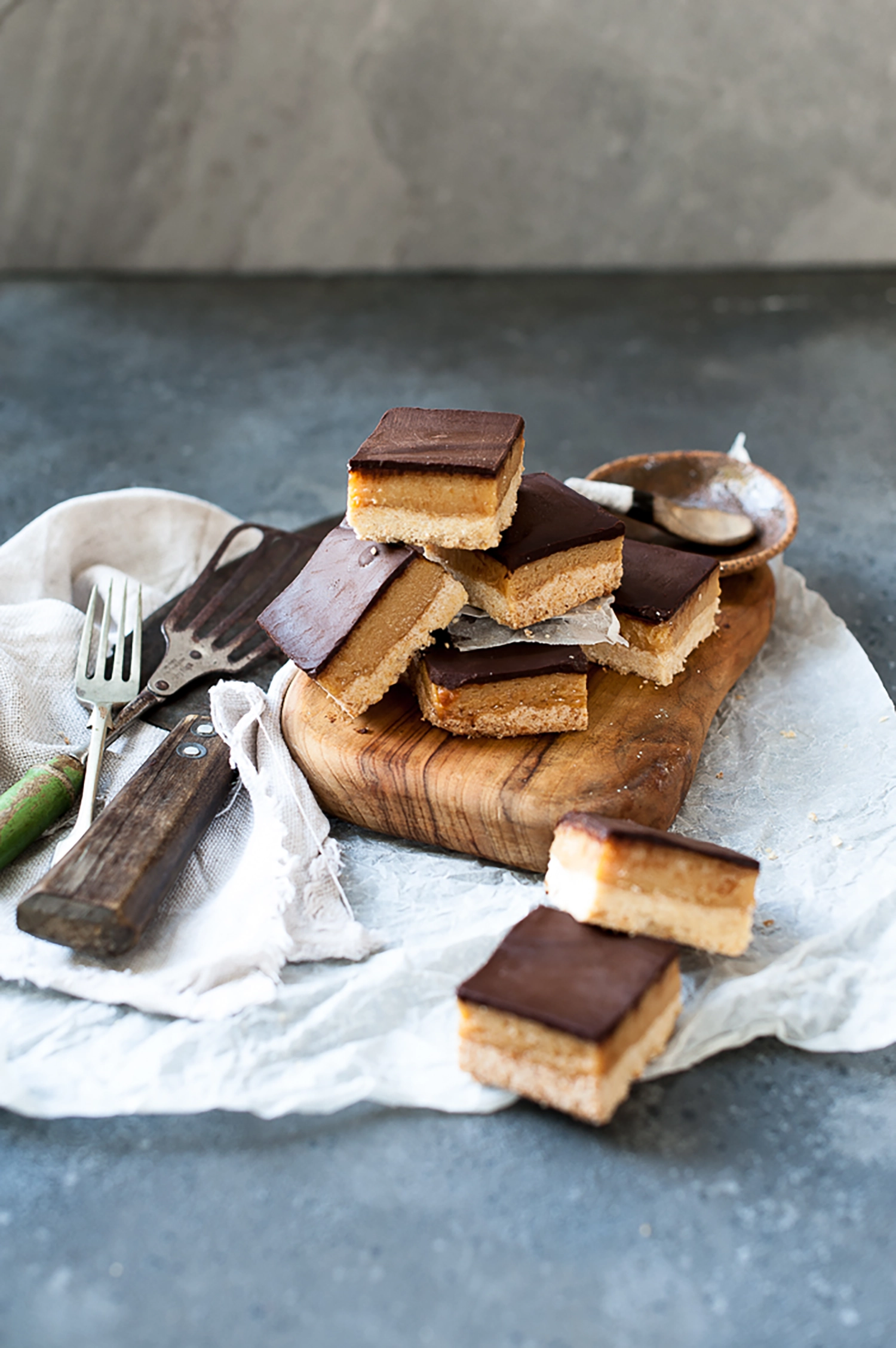 Gluten free salted caramel slice with buttery coconut base, thick caramel filling and smooth dark chocolate topping. The perfect sweet and salty treat for afternoon tea.