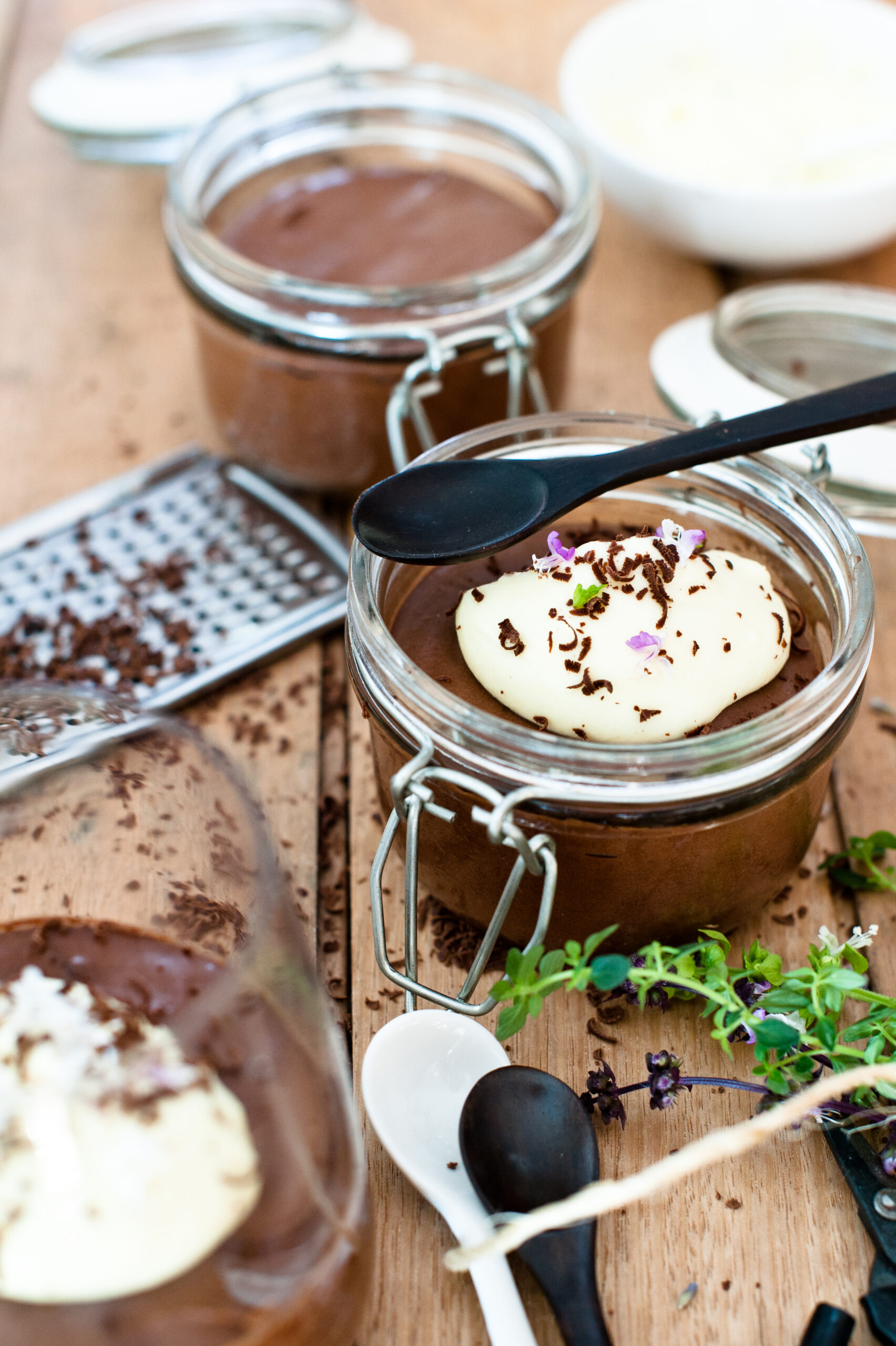 dark chocolate mousse in little glass pots topped with creme.