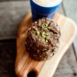 stacked cafe style chocolate date anza biscuits with a coffee