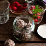 little chocolate truffles in a glass jar on a timber table
