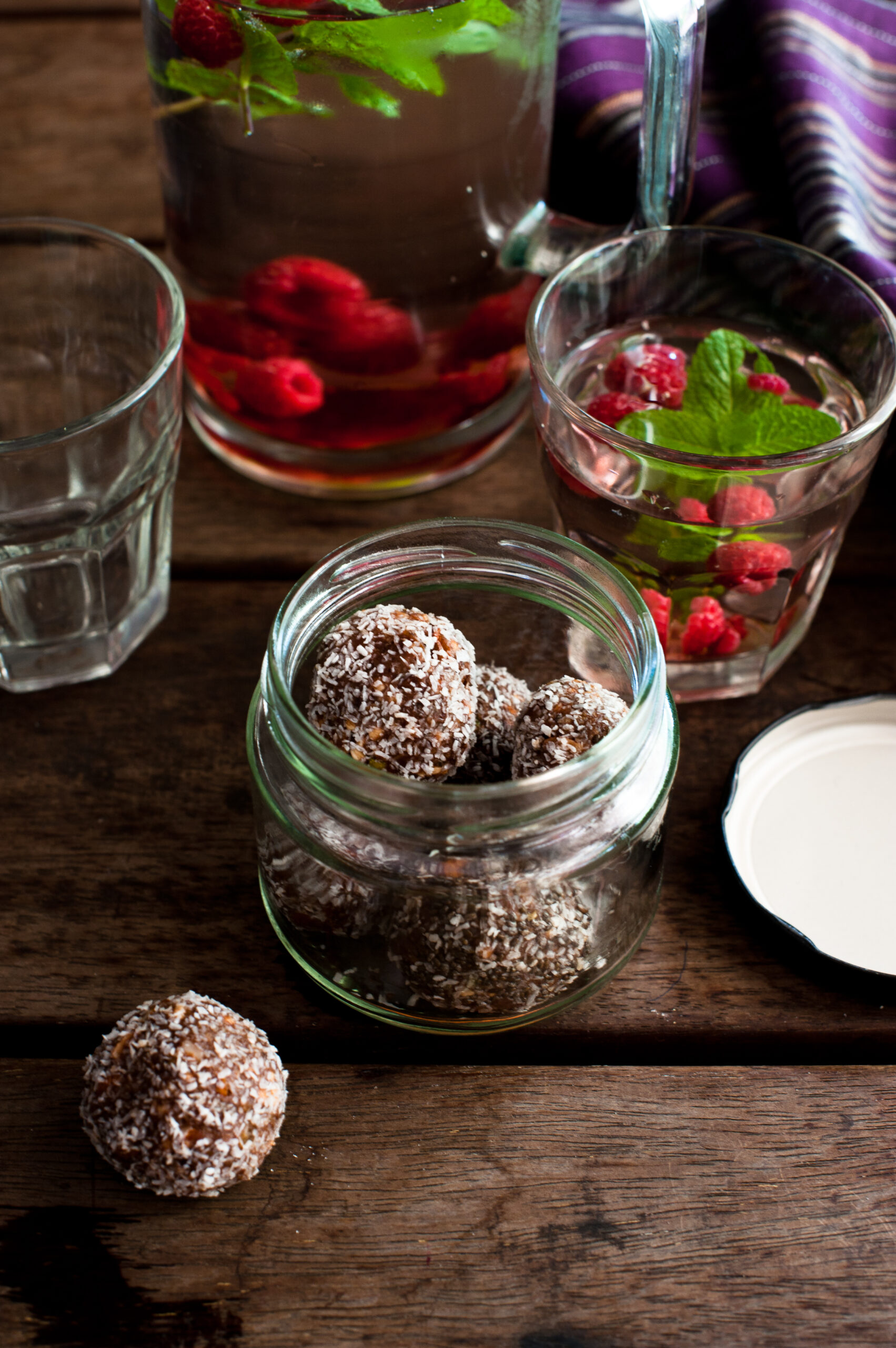 little chocolate truffles in a glass jar on a timber table