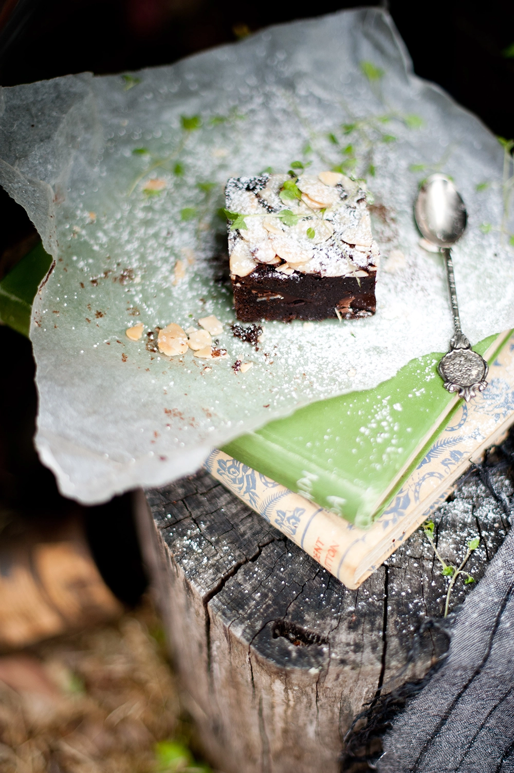 gluten free chococlate brownie dusted with icing sugar and flaked almond