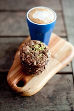 Date syrup adds rich, natural sweetness to these gluten free ANZAC-style biscuits with dark chocolate and pistachio. A modern twist on a classic.