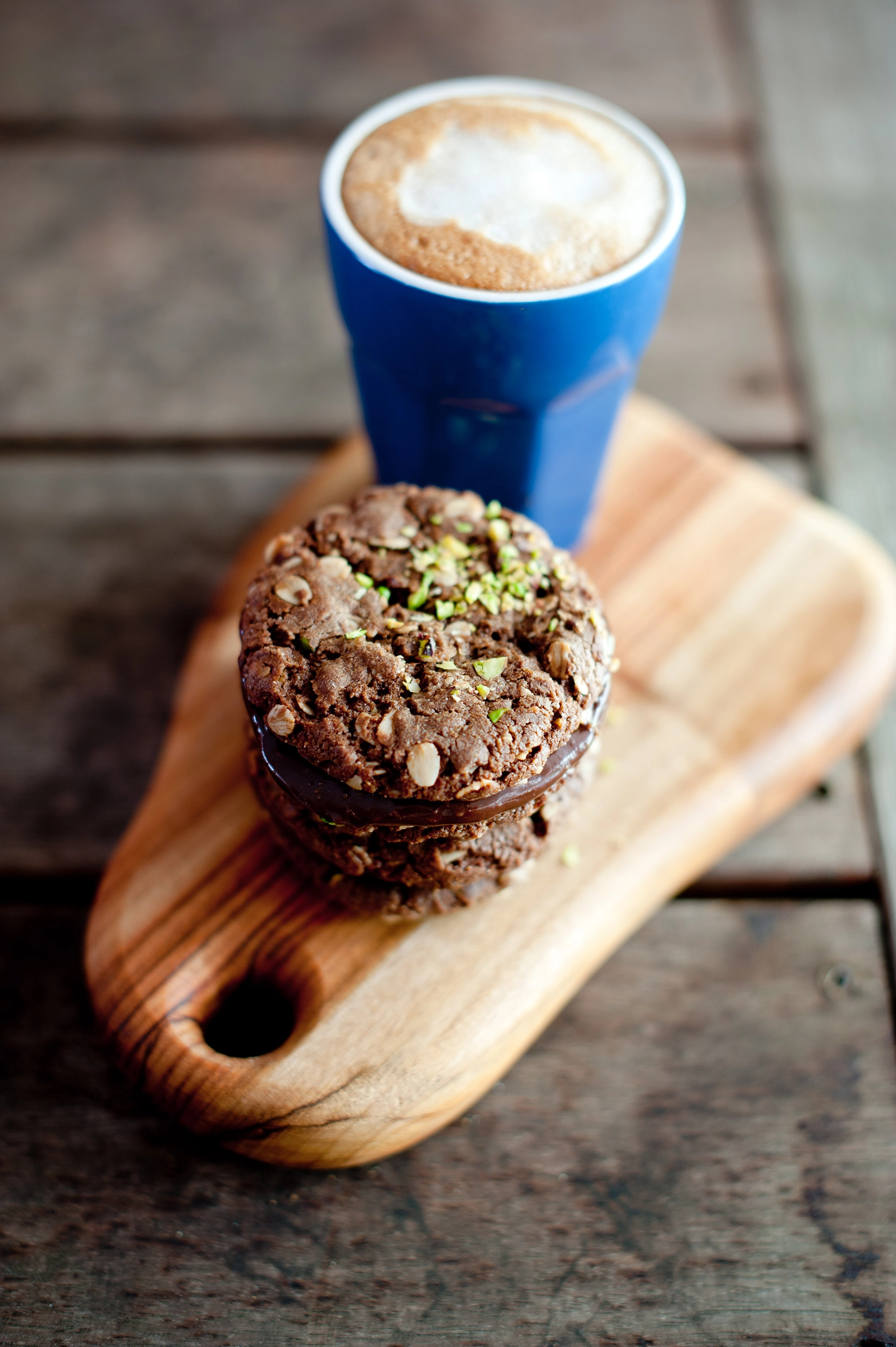 Date syrup adds rich, natural sweetness to these gluten free ANZAC-style biscuits with dark chocolate and pistachio. A modern twist on a classic.